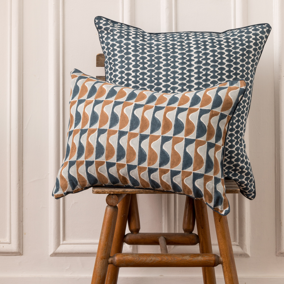 floral throw pillow in natural linen with solid blue pillow